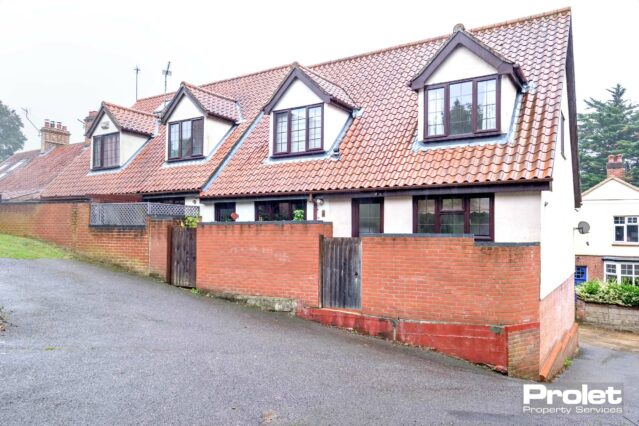 Brick house with brick wall.