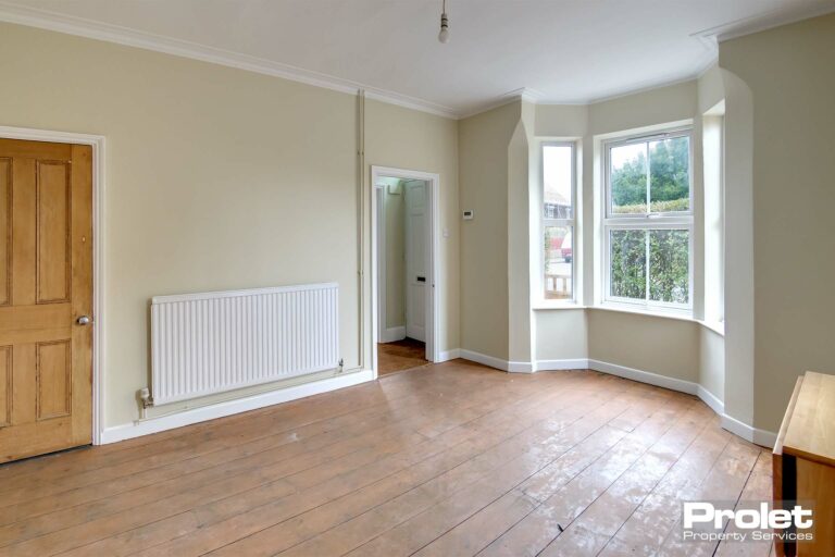 Dining room with stripped floors, magnolia walls and tiled fireplace