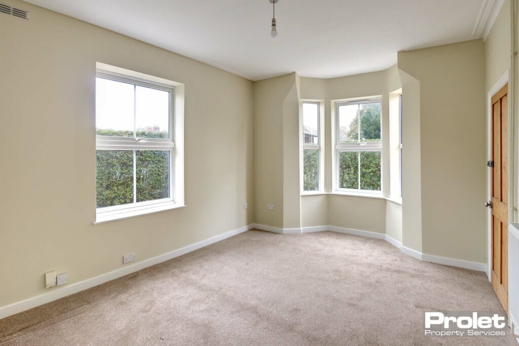 Lounge with magolia walls and new carpets. Bay window