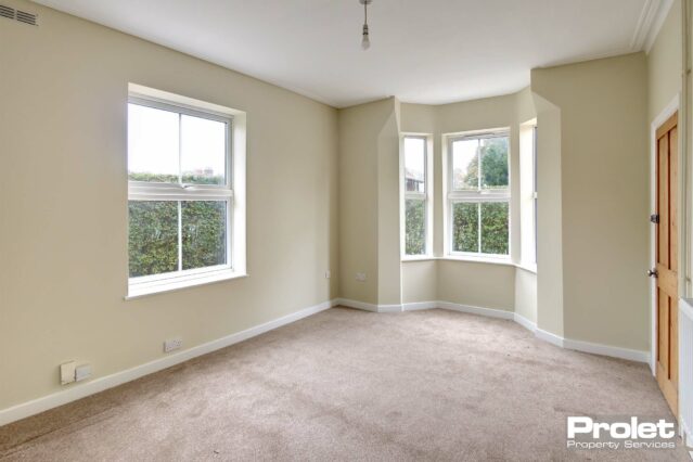 Lounge with magolia walls and new carpets. Bay window