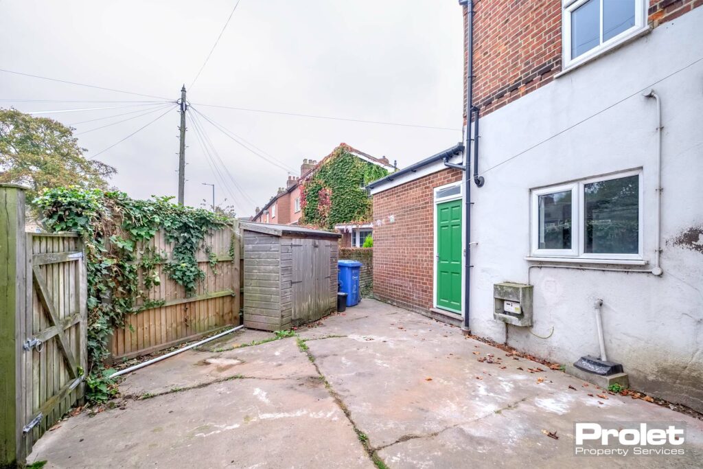 Enclosed garden with storage shed