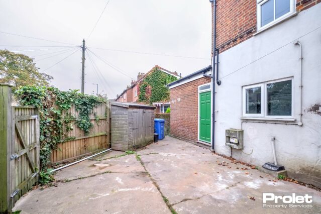 Enclosed garden with storage shed