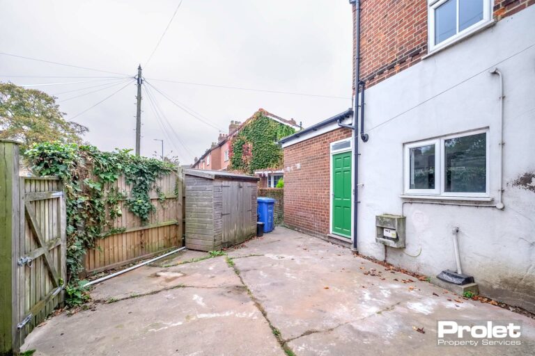 Enclosed garden with storage shed