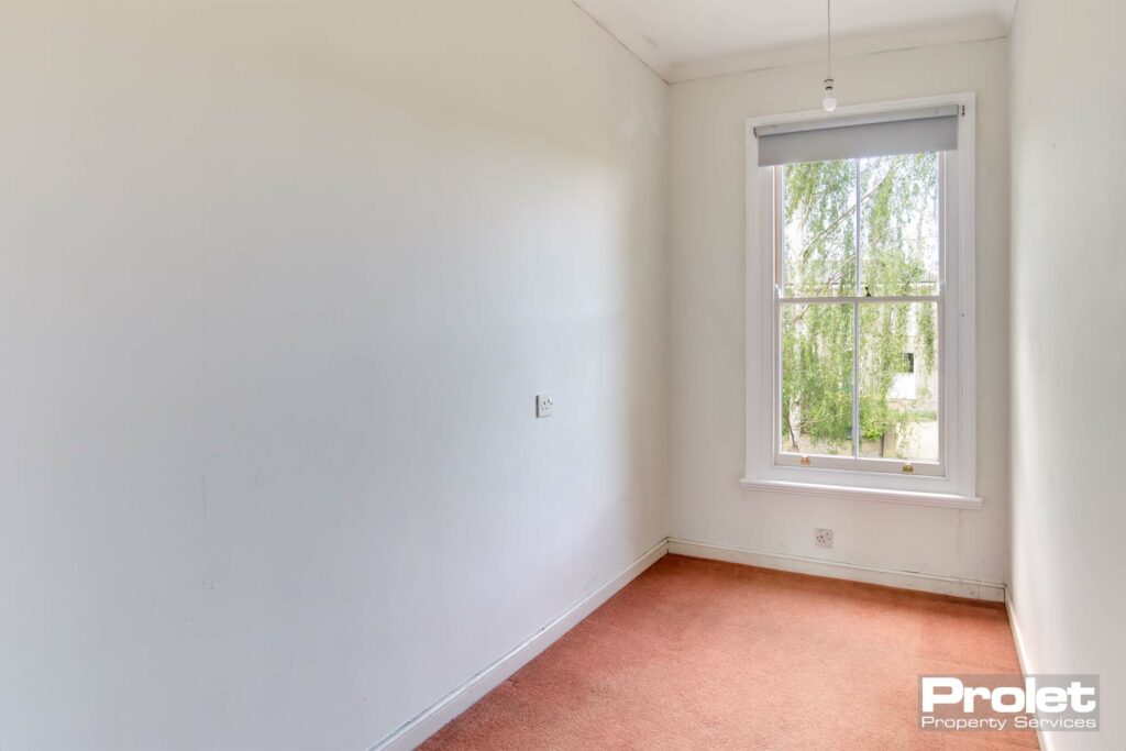 Peach carpet with white walls