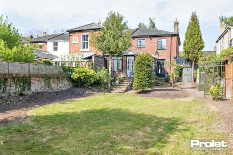 Steps into garden with lawn arear and brick walls