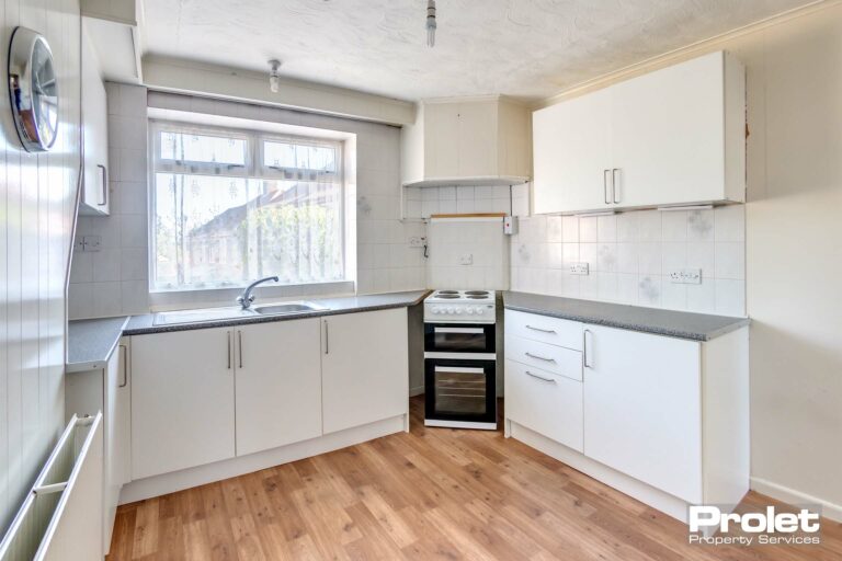 Laminate flooring, white units and grey worktops
