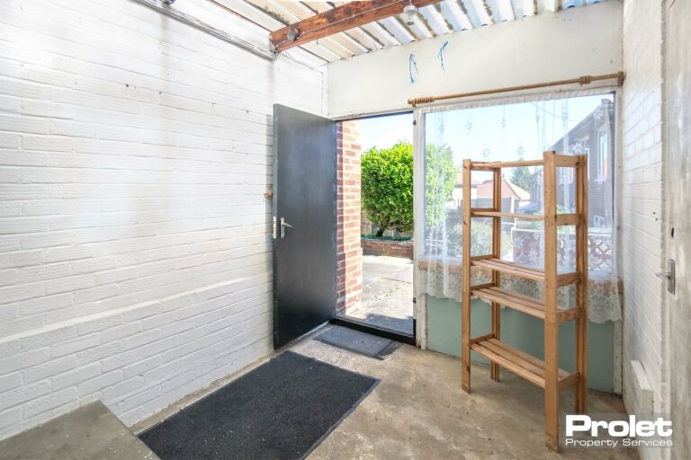 Concrete floor with white walls and external door