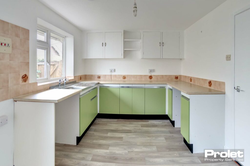 Fitted kitchen with green cabinets