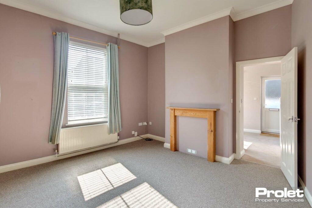 Living room with grey carpet and mushroom coloured walls