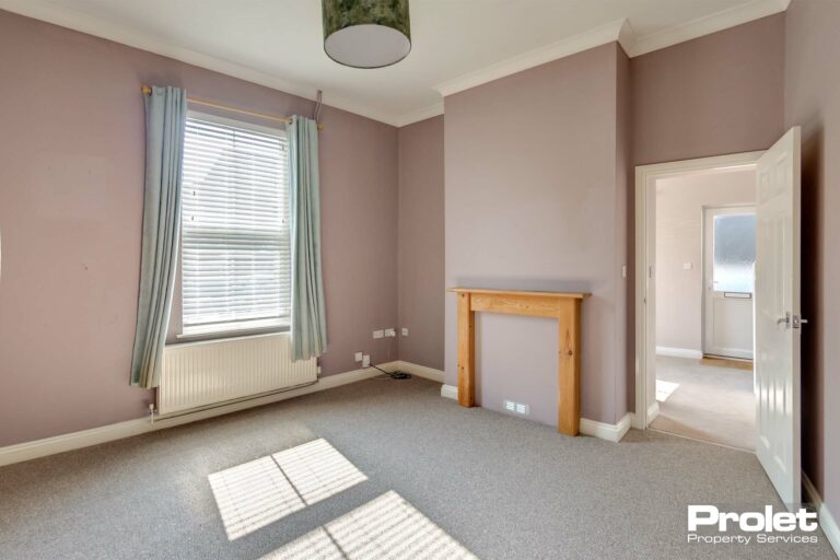 Living room with grey carpet and mushroom coloured walls