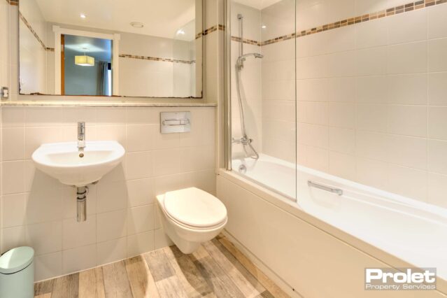 White suite with laminate flooring and white suite