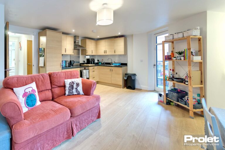 laminate flooring and off whoite walls with sofa, dining set and kitchen with appliances