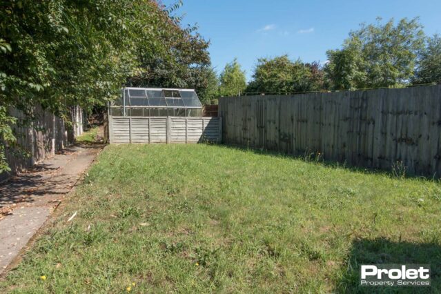 Large rear garden with lawn