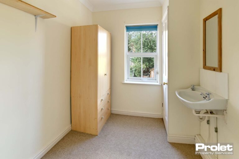 Box room with wardrobe and sink