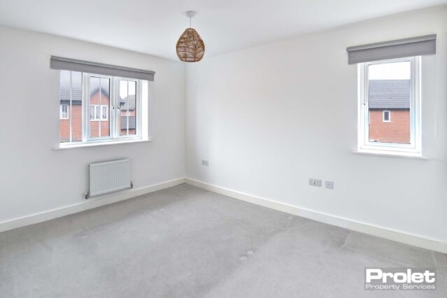 White walls and grey carpets with blinds in windows