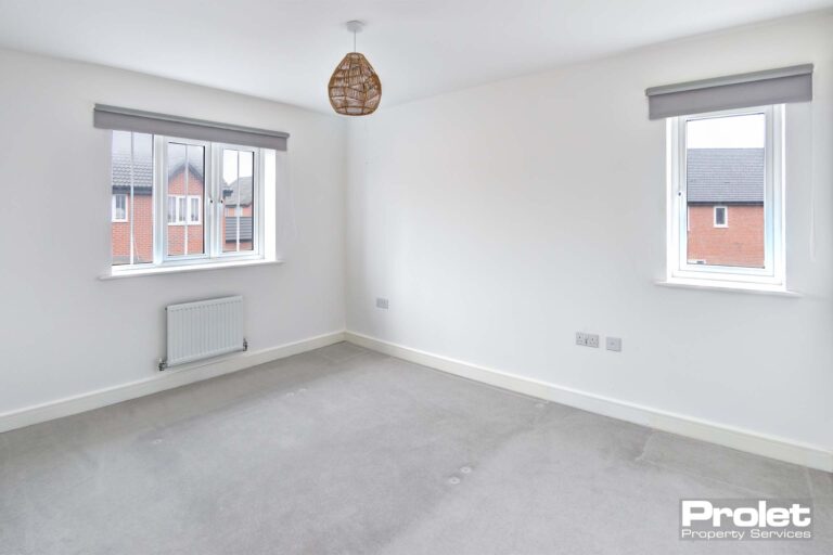 White walls and grey carpets with blinds in windows
