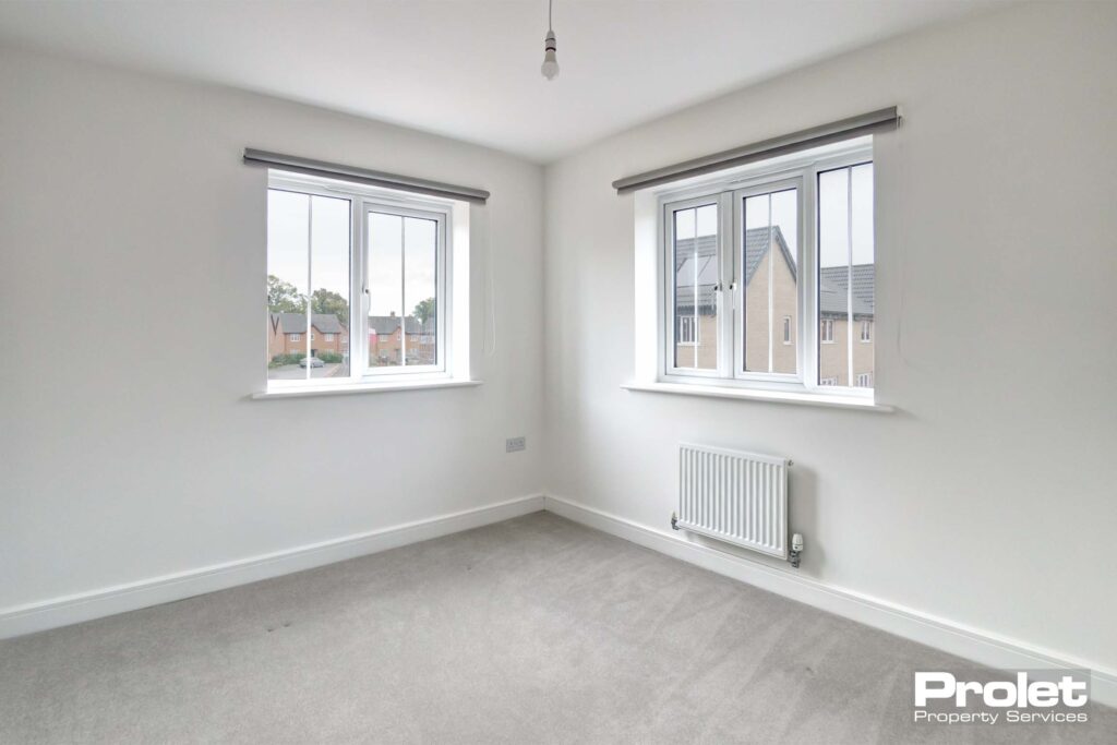 White walls and grey carpets with blinds in windows