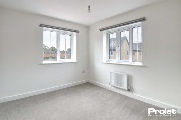 White walls and grey carpets with blinds in windows
