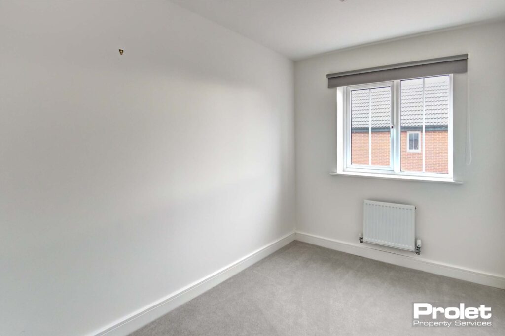 White walls and grey carpets with blinds in windows