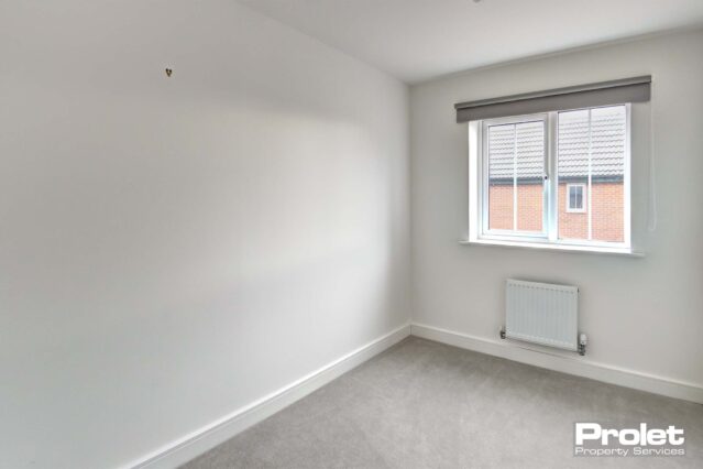 White walls and grey carpets with blinds in windows