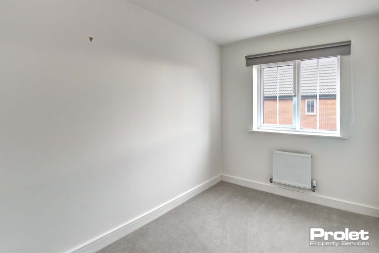 White walls and grey carpets with blinds in windows
