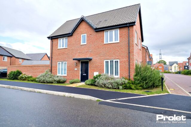 Red brick building with driveway