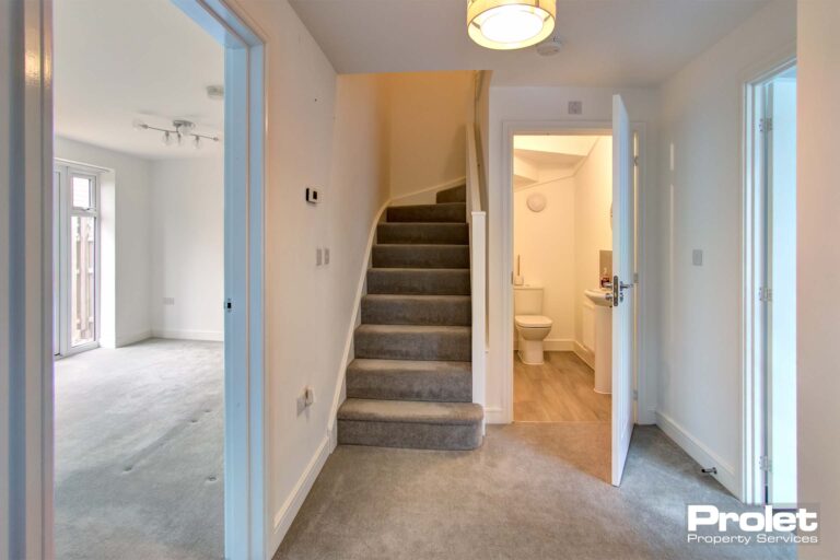 White walls and grey carpets, Stairs leading to first floor and ground floor W.C