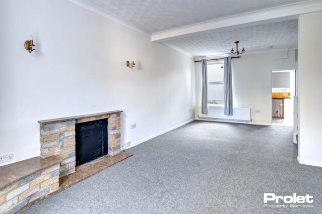 Open plan living/dining room with brick fireplace