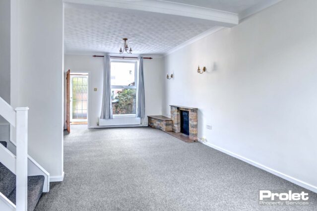 Open plan living/dining room with brick fireplace