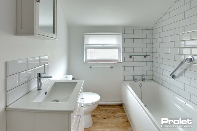Bathroom with toilet, sink, and bath