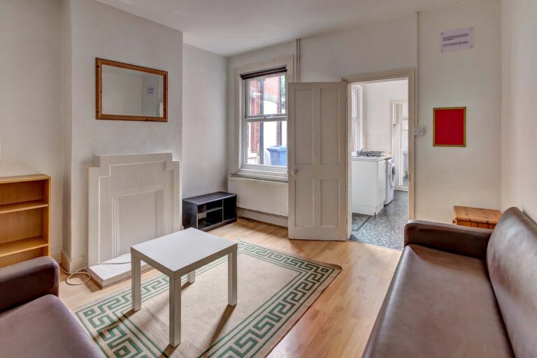 Living room with wooden floor, sofas, and coffee table