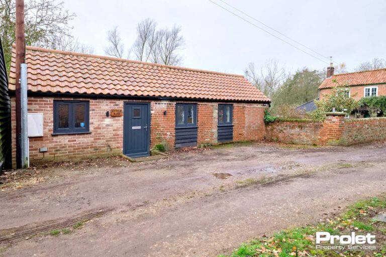 Red brick building with black doors and windows