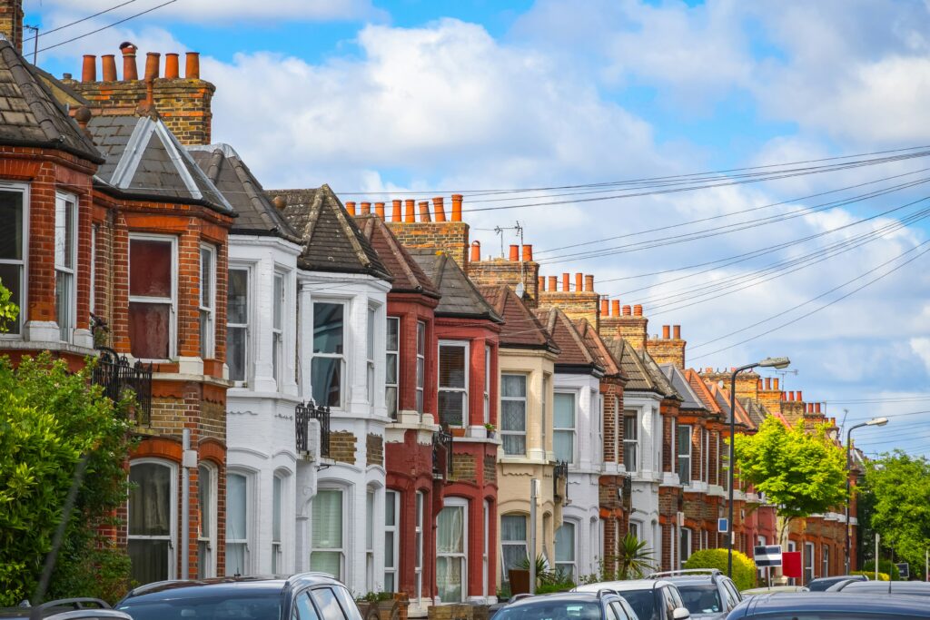 Row of traditional terraced houses on a sunny Norwich street.