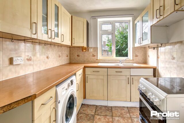 Fitted kitchen with oven and gifted washing machine. Beech effect work tops and tiled floor.