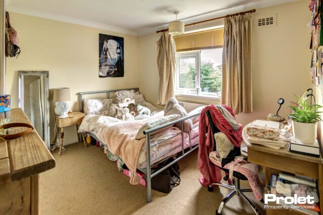 Large bedroom with double bed and desk