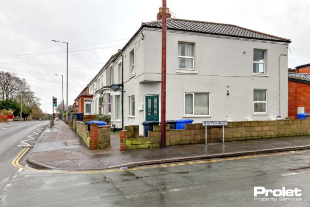 Painted off white with UPVC windows and communal floors