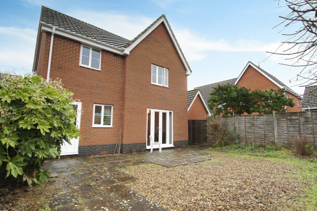 View of property from rear, gravel garden and patio area.