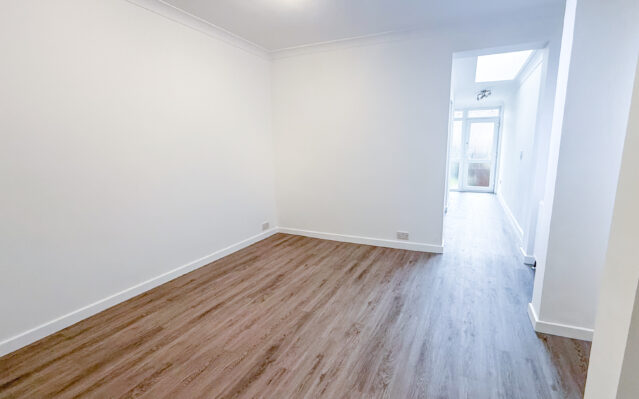 Dining room with laminate wood effect flooring and white walls