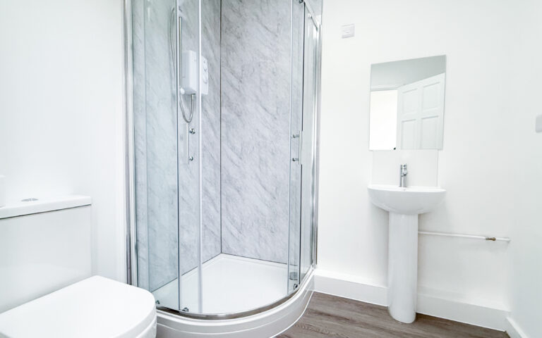 Shower room with shower cubicle, sink, and toilet