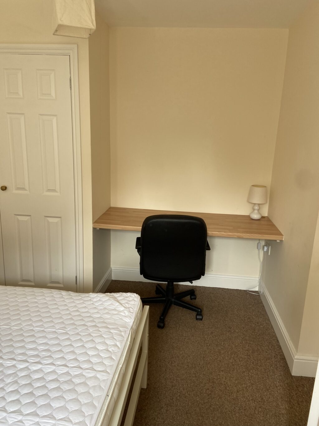 Bedroom with double bed, desk, and desk chair