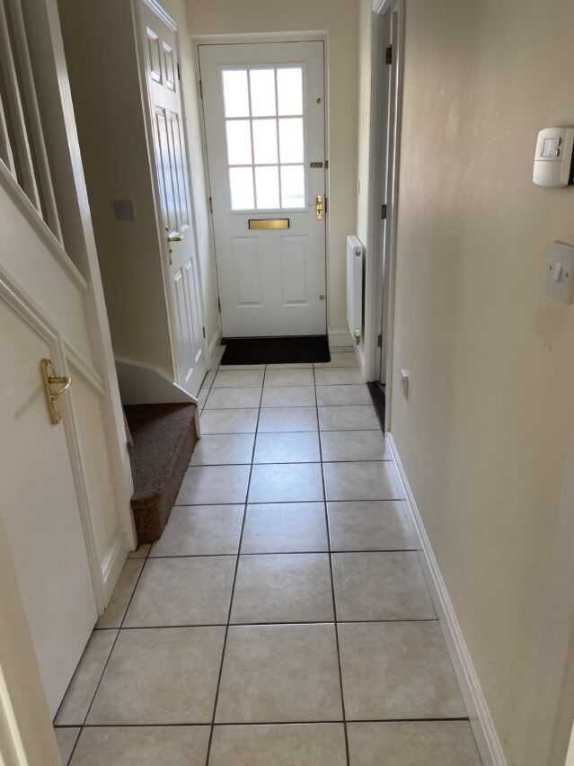 Tiled hallway leading to front door