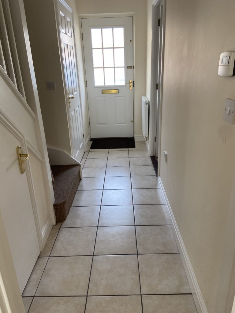 Tiled hallway leading to front door