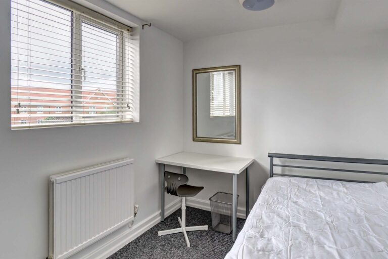 Bedroom with double bed and desk