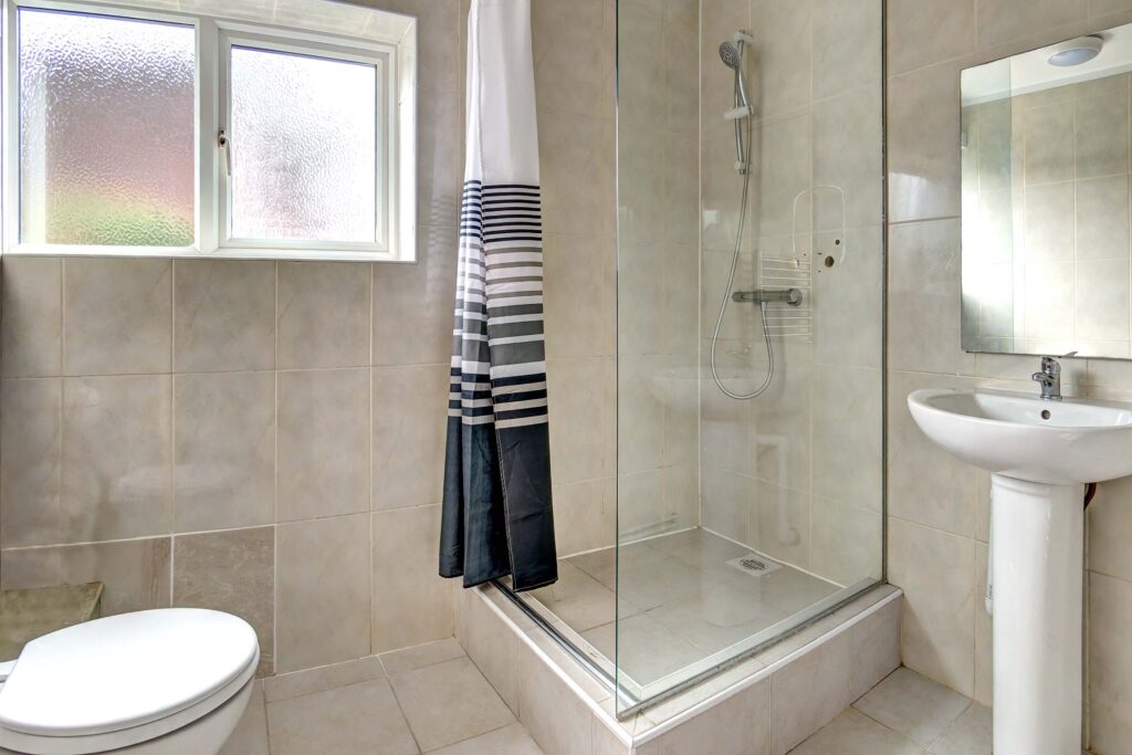 Family bathroom with shower cubicle, toilet, and sink