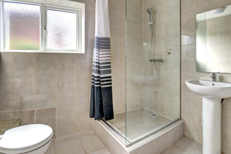 Family bathroom with shower cubicle, toilet, and sink