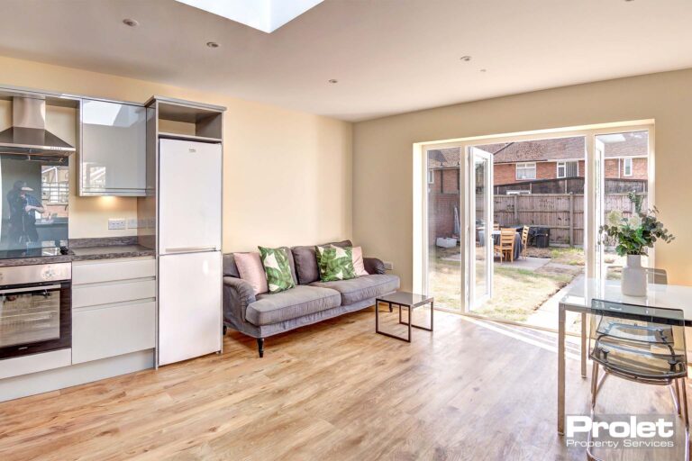 Large kitchen with modern fittings, sofa, and dining set